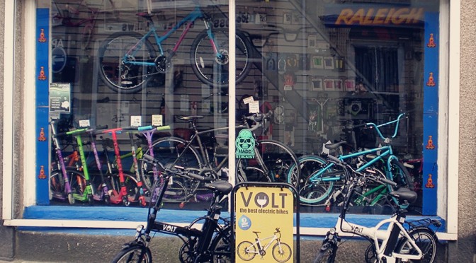 Aldridge Cycles shop with Volt Metro e-bikes and road sign