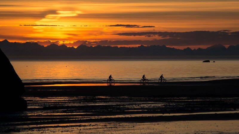 Cycling along the coast at sunset