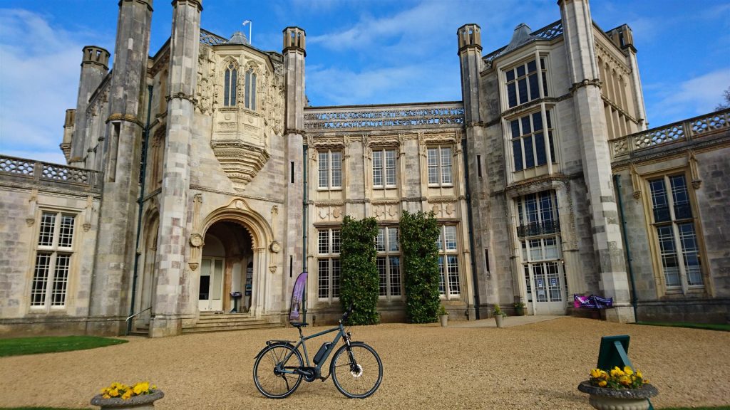 The VOLT Infinity e-bike in front of Highcliffe Castle