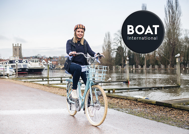 A cyclist rides her VOLT Kensington e-bike along the canal