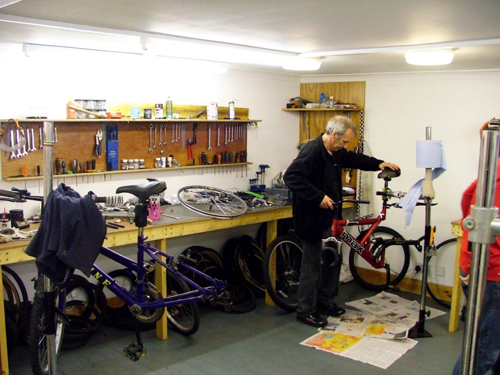 A Shetland Community Bike Project staff member services a bike